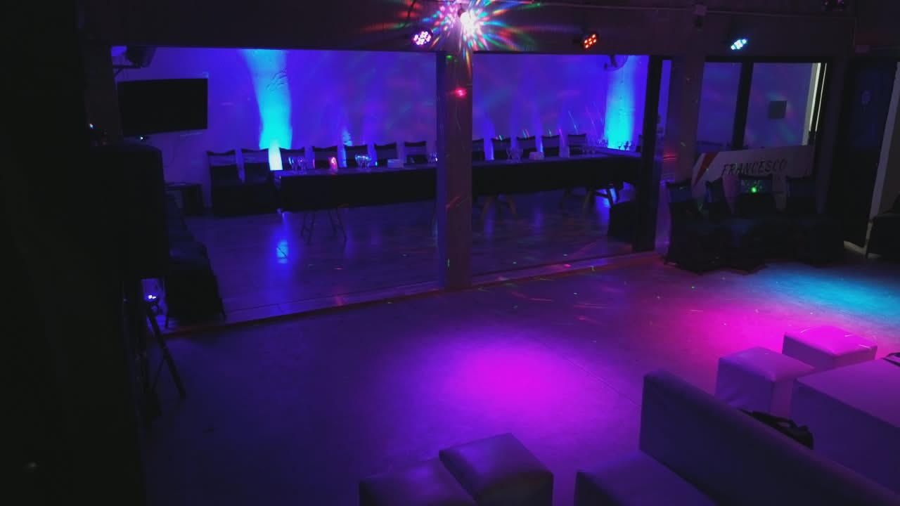 Zona lounge con pista de baile, sillones y luces violeta
